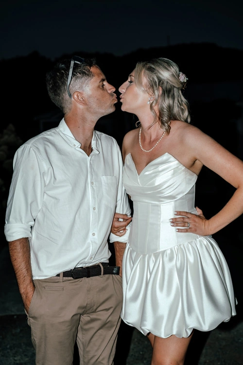Bride wearing short skirt version of convertible wedding dress with corset bodice – Auckland, New Zealand.