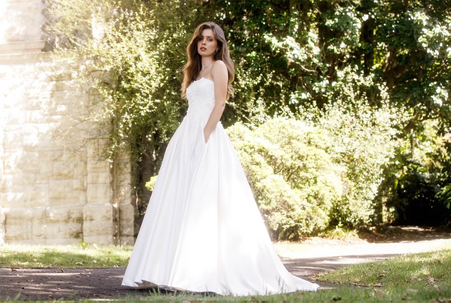 Classic A-line wedding dress with full satin skirt and blossom appliqued lace bodice.