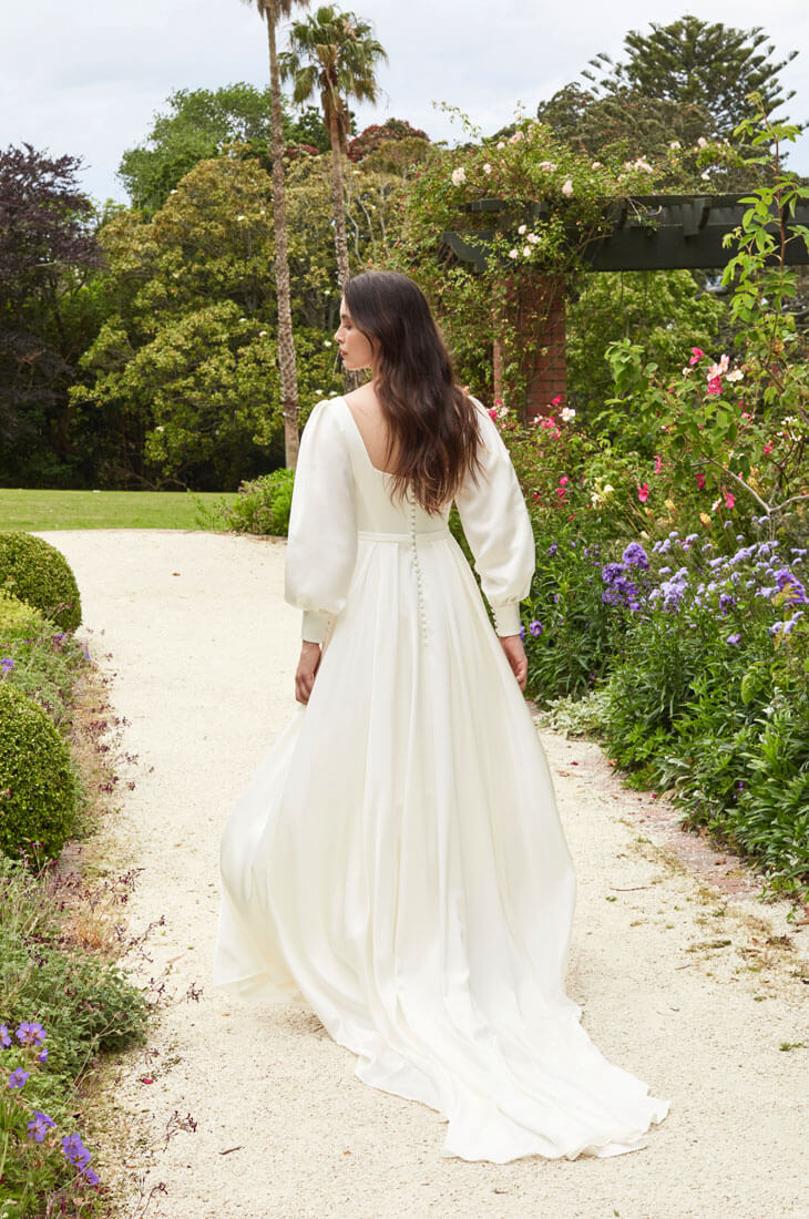 Long sleeve wedding dress with billowing skirt.
