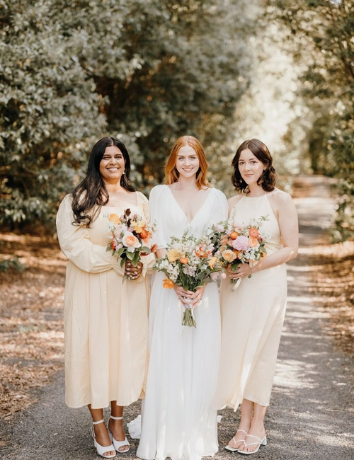 Bride and bridesmaids in pastels, summer day.