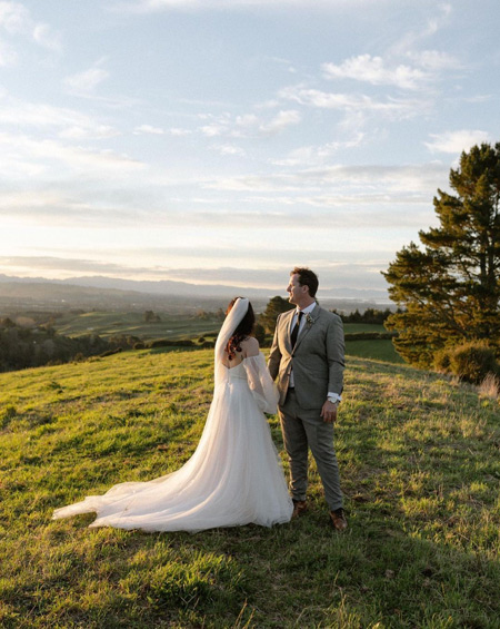Bride and groom surrounded by NZ landscape.