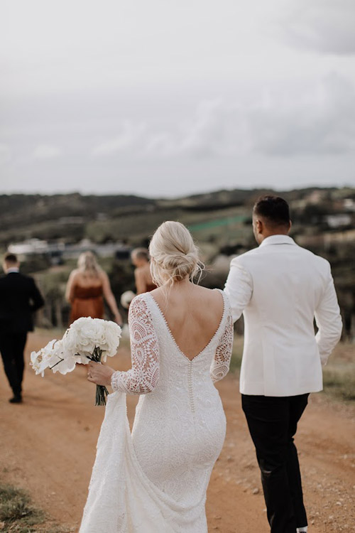 Real wedding, bride and groom walking.