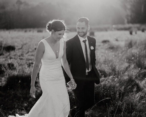 Bride and groom, walking in the countryside.