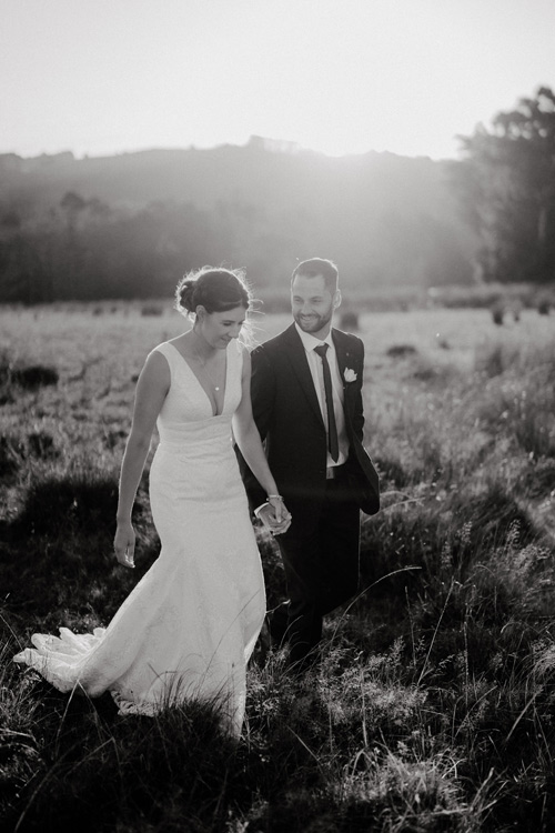 Bride and groom, walking in the countryside.