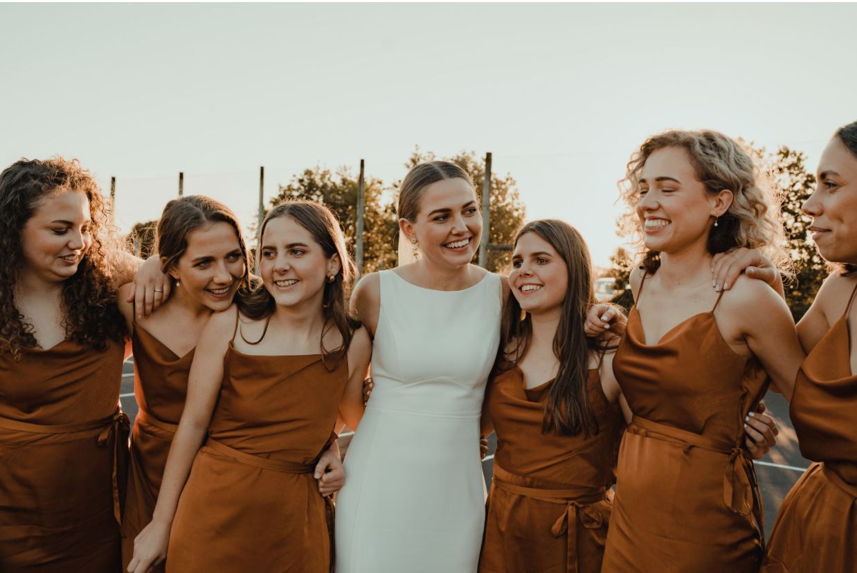 Bride surrounded by her bridesmaids.