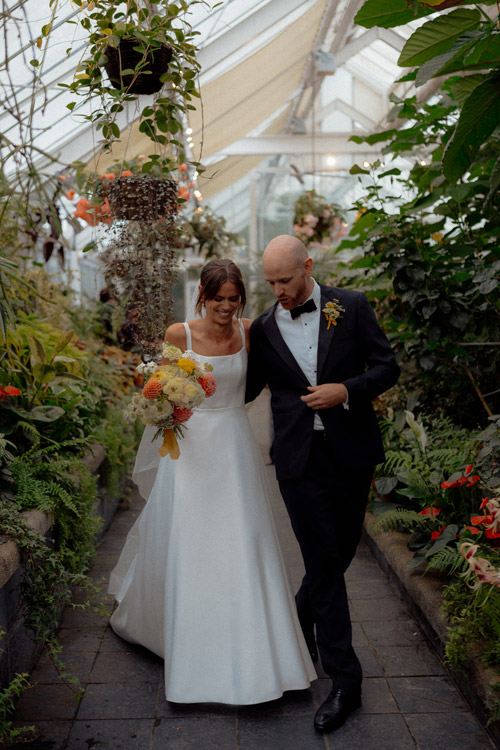 Bride and groom in botanical hot house.
