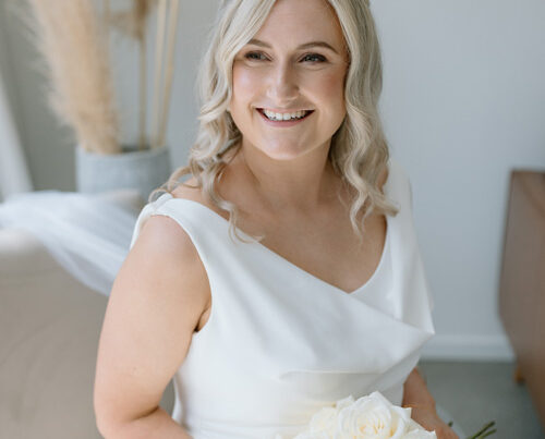 Real bride wearing a cowl neck wedding dress.