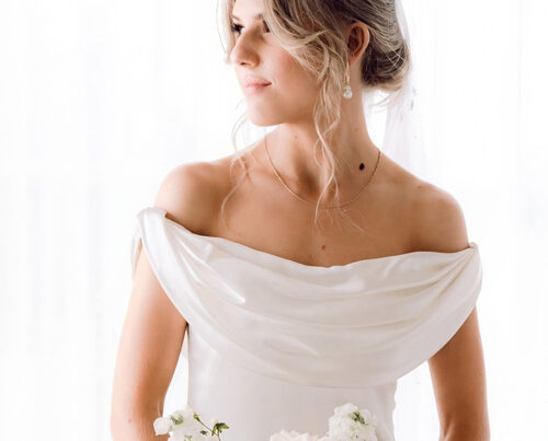 Real bride in silk wedding dress with bouquet.