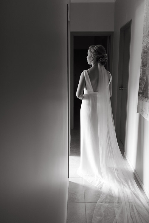 Real bride wearing a simple wedding dress, back.