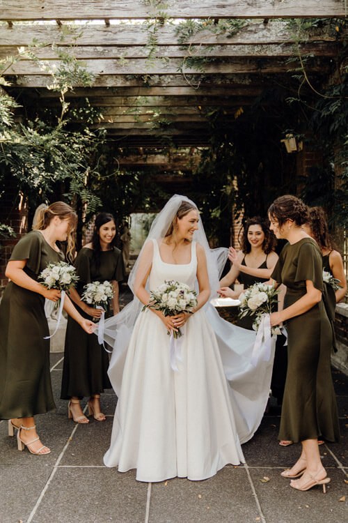 Real bride, surrounded by bridesmaids.