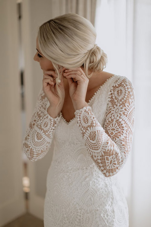 Real bride wearing a vintage lace wedding dress.