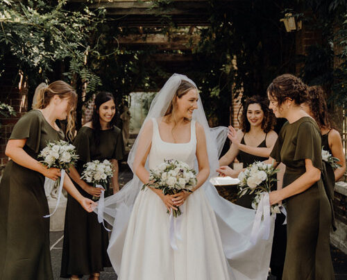 Real bride surrounded by her bridesmaids.
