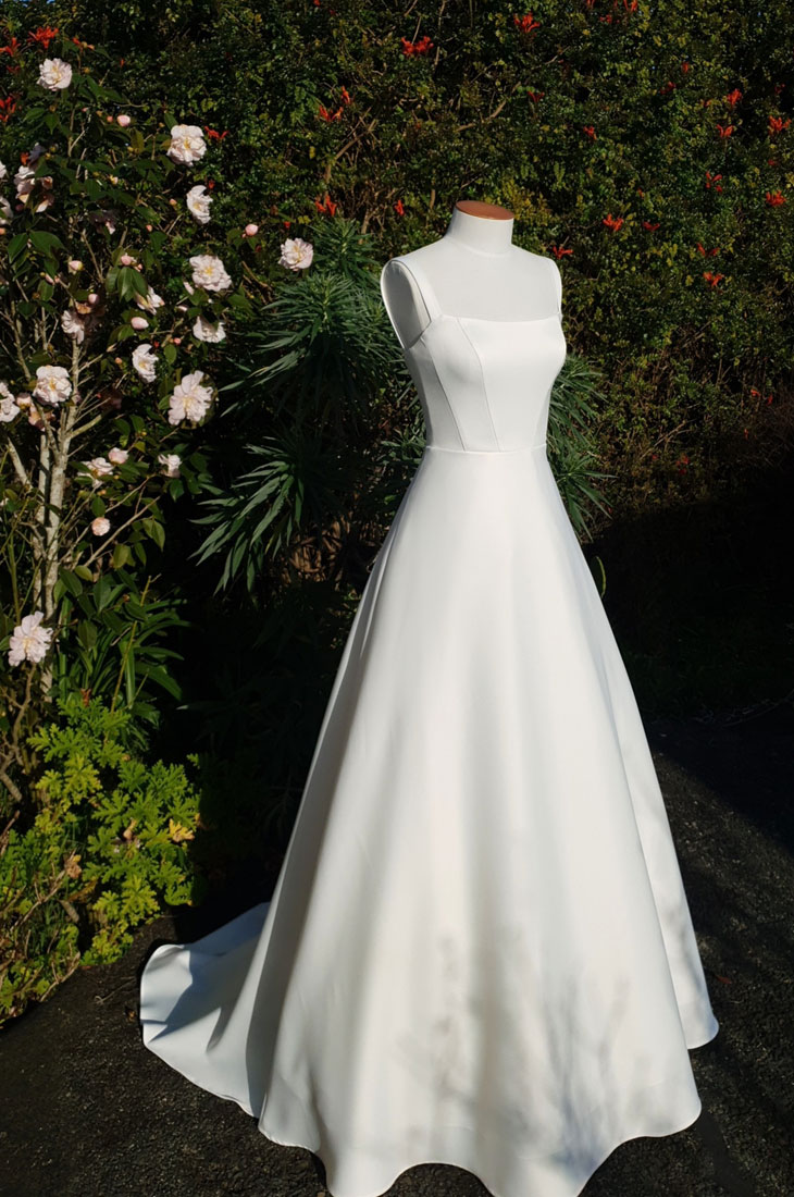 Simple A-line wedding dress with wide neckline.