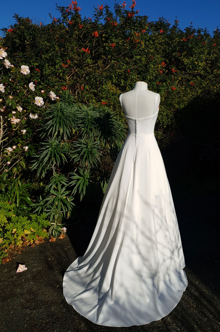 Beautiful A-line wedding dress with corset and buttoned back.