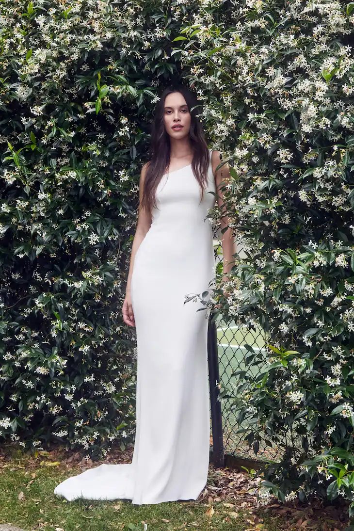 One shoulder designer wedding dress by NZ bridal designer Anna Schimmel, fitted crepe gown with small train.