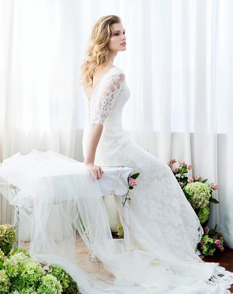 Fitted long sleeve wedding dress in French ivory lace with a flattering silhouette, designed in Auckland, NZ.