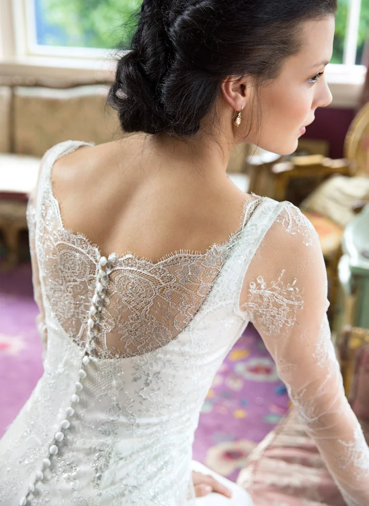 Long sleeve wedding dress in sheer lace with buttons, by Anna Schimmel Bridal, Auckland, NZ.