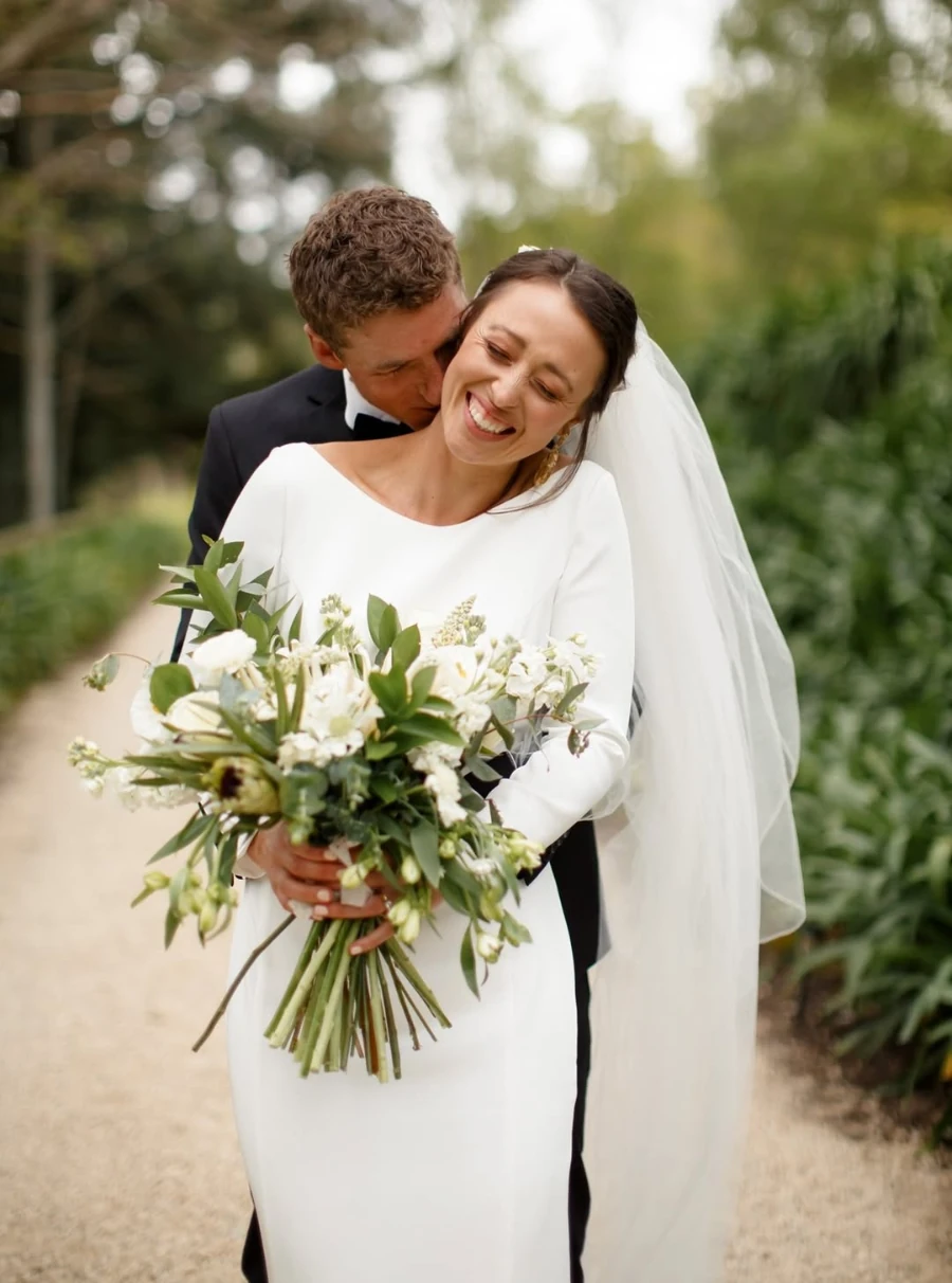 Modest long sleeve wedding dress featuring covered shoulders and classic tailoring, made in New Zealand.