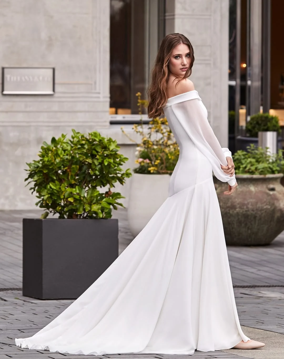 Off-the-shoulder long sleeve wedding dress with soft neckline and modern romance, by Anna Schimmel Bridal, Auckland.