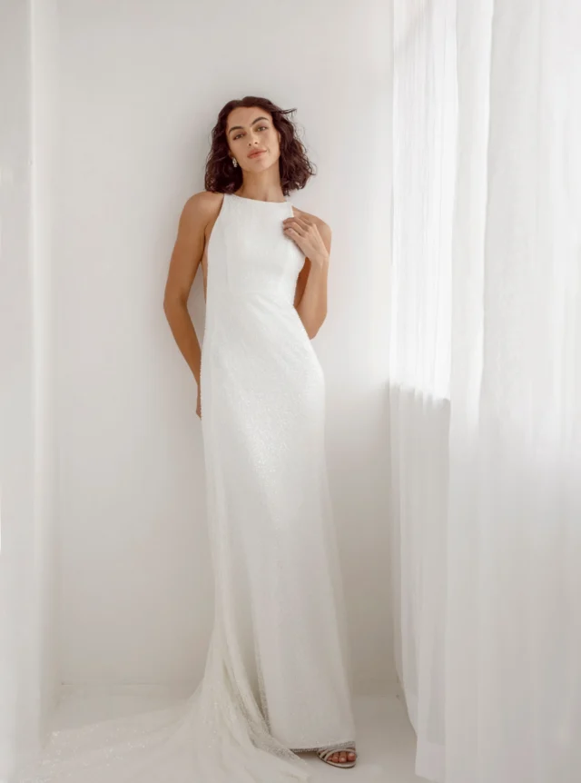 Elegant in sparkling beading.

This tailored wedding dress is cut with a high neckline and deep side cut-outs, creating a clean, sculpted silhouette. Draping beaded tulle falls over the gown, catching the light with every movement.

Minimalist in line, with just the right amount of sparkle.

Wedding Dresses Auckland
Anna Schimmel

Each wedding dress purchased keeps a girl in Togo, Africa, in school for a year.

#AnnaSchimmel #WeddingDressesAuckland #NZBridal #BeadedWeddingDress #MinimalistWeddingDress #ModernBride