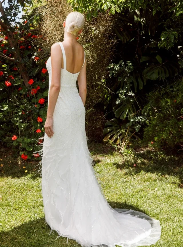 1920s-inspired, slender and soft.

This fitted wedding dress is richly beaded throughout, with delicate marabou feathers adding softness and movement. Wide straps frame the square front neckline and low square back, while the skirt falls into a gentle puddle train.

A glamorous gown that truly comes to life in motion.

Each wedding dress purchased keeps a girl in Togo, Africa, in school for a year.

Wedding Dresses Auckland
Anna Schimmel

#AnnaSchimmel #AucklandWeddings #NZBridal #BeadedWeddingDress #1920sWeddingDress #FeatherWeddingDress