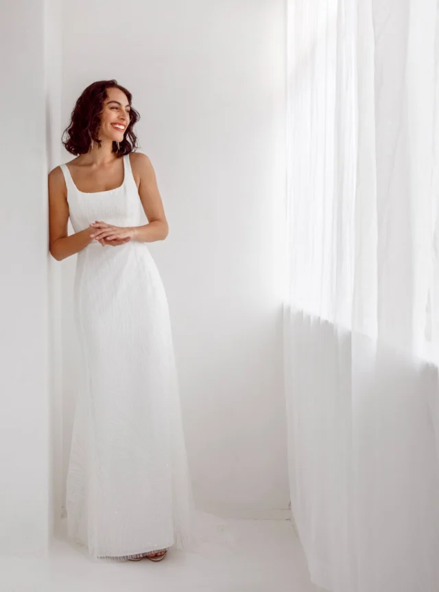 Katrina is quietly beautiful.

Minimalist and beautifully understated, Katrina is cut with a soft square neckline and a slender fit-and-flare silhouette. Fine embroidered lace creates delicate vertical lines, while a scattering of sequins catches the light without overpowering the simplicity of the gown. The result is elegant, modern and effortless.

Each wedding dress purchased keeps a girl in Togo, Africa, in school for a year.

Wedding Dresses Auckland
Anna Schimmel

#AnnaSchimmel #SimpleWeddingDress #MinimalistWeddingDress #SquareNeckWeddingDress #LaceWeddingDress #FitAndFlareWeddingDress #NZBride #NZWeddings