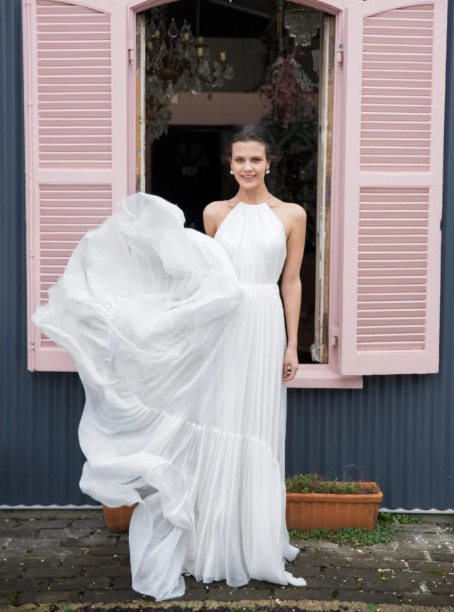 Dreamy in floaty chiffon.

Soft, romantic and beautifully light, this Grecian-inspired chiffon wedding dress is created in layers of sheer, flowing fabric.

The halter-neck bodice is finely gathered and cut with a low back, while a softly ruffled tier adds movement, volume and a touch of drama to the ethereal skirt.

A beautiful choice for a bride who wants her wedding dress to feel effortless, feminine and made to move.

#ChiffonWeddingDress #HalterNeckWeddingDress #GrecianWeddingDress #FloatyWeddingDress #WeddingDressInspiration #NZBride #NZWeddings