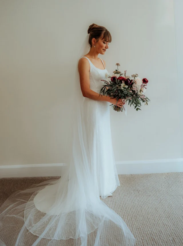 Nicky in Katrina 🤍

There is something so lovely about a simple wedding dress that lets the bride herself shine.

Katrina’s softly fitted silhouette, delicate embroidered lace and subtle sparkle gave Nicky an elegant, romantic look, finished with a long sheer veil and that gorgeous loose bouquet.

After her wedding Nicky told me, “I felt stunning all day long!” And really, that says it all.

A wedding dress should make you feel beautiful, move with you, dance with you and let you enjoy every wonderful moment of the day.

Featured: Katrina.

@thinkvisualnz 
#AnnaSchimmel #RealBride #RealWedding #NZBride #NZWeddings #SimpleWeddingDress #LaceWeddingDress #AucklandWeddings